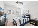 Clean, well-lit bedroom with a ceiling fan, television, framed wall art, and a comfortable bed at 18117 Gawthrop Dr # 101, Lakewood Ranch, FL 34211