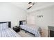Bright bedroom featuring two beds with matching blue plaid bedding and neutral walls at 18117 Gawthrop Dr # 101, Lakewood Ranch, FL 34211