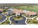 Beautiful exterior of the clubhouse with circular driveway and manicured landscaping at 18117 Gawthrop Dr # 101, Lakewood Ranch, FL 34211