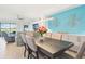 Open concept dining room featuring an accent wall, modern light fixture and seating for six at 18117 Gawthrop Dr # 101, Lakewood Ranch, FL 34211