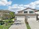 Beautiful home exterior with stone accents, tile roof, two-car garage, and well-maintained landscaping at 18117 Gawthrop Dr # 101, Lakewood Ranch, FL 34211