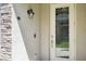 Detailed close-up of the front door with decorative glass, stone surround and modern hardware at 18117 Gawthrop Dr # 101, Lakewood Ranch, FL 34211