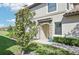 Inviting front entrance showcasing lush landscaping and charming stone accents at 18117 Gawthrop Dr # 101, Lakewood Ranch, FL 34211
