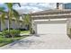 A large two car garage with a beautiful stone driveway and manicured lawn at 18117 Gawthrop Dr # 101, Lakewood Ranch, FL 34211