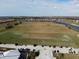 Expansive golf course view complete with golf carts, lush greens, and residential homes in the background at 18117 Gawthrop Dr # 101, Lakewood Ranch, FL 34211