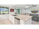 Kitchen island with a granite countertop, stainless steel dishwasher and barstool seating at 18117 Gawthrop Dr # 101, Lakewood Ranch, FL 34211