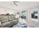 Bright living room showcases an open floor plan and leads to an outdoor patio, offering seamless indoor/outdoor living at 18117 Gawthrop Dr # 101, Lakewood Ranch, FL 34211