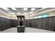 Spacious locker room featuring numerous wooden lockers and a central island with a countertop at 18117 Gawthrop Dr # 101, Lakewood Ranch, FL 34211