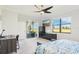 Bright bedroom featuring a ceiling fan, television, and a sliding glass door that opens to an outdoor patio at 18117 Gawthrop Dr # 101, Lakewood Ranch, FL 34211