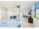 Bright main bedroom featuring a ceiling fan, workspace, golf course views, and access to an outdoor patio at 18117 Gawthrop Dr # 101, Lakewood Ranch, FL 34211