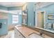 Bathroom featuring double vanity, tile accents, large mirrors, and soaking tub at 1878 Killdeer Ct, Venice, FL 34293
