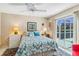Cozy bedroom with a sliding glass door to the lanai and plenty of natural light at 1878 Killdeer Ct, Venice, FL 34293
