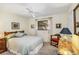 Bedroom with neutral walls, carpeted flooring, ceiling fan, and bright windows at 1878 Killdeer Ct, Venice, FL 34293