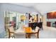 Bright dining area features tile flooring, views of the outdoor lanai, and access to the kitchen and breakfast bar at 1878 Killdeer Ct, Venice, FL 34293