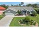 Charming single-story home featuring a well-manicured lawn and mature landscaping at 1878 Killdeer Ct, Venice, FL 34293