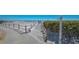 Beach entrance featuring pathway and outdoor shower, surrounded by tropical vegetation at 1925 Gulf Of Mexico Dr # G8-206, Longboat Key, FL 34228
