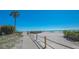Picturesque beach path lined with tropical greenery, leading to the ocean at 1925 Gulf Of Mexico Dr # G8-206, Longboat Key, FL 34228