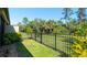 Spacious backyard with lush lawn, secure fencing, and surrounding greenery for privacy at 20186 Benissimo Dr, Venice, FL 34293