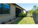 Private backyard with a black metal fence, lush green lawn, and attractive landscaping at 20186 Benissimo Dr, Venice, FL 34293