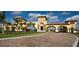 Grand entrance to the community with manicured lawns and rows of palm trees at 20186 Benissimo Dr, Venice, FL 34293