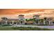 Grand entrance to the community featuring lush landscaping, elegant architecture, and a welcoming atmosphere at 20186 Benissimo Dr, Venice, FL 34293
