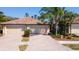 Charming villa with a brick driveway, two-car garage, and a beautifully landscaped front yard at 20186 Benissimo Dr, Venice, FL 34293