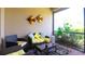 Comfortable outdoor screened lanai featuring seating and a coffee table with views of lush greenery at 20186 Benissimo Dr, Venice, FL 34293