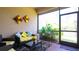 Outdoor screened lanai featuring comfortable seating, a coffee table, and views of lush greenery at 20186 Benissimo Dr, Venice, FL 34293