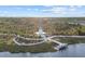 Scenic view of a park featuring a lighthouse-style structure and a pier extending into the water, surrounded by lush greenery at 20186 Benissimo Dr, Venice, FL 34293