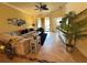Bright living room with tile floors, a ceiling fan, and a comfortable sectional sofa at 20186 Benissimo Dr, Venice, FL 34293