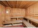 Relaxing sauna room with wood paneling and wooden benches at 20186 Benissimo Dr, Venice, FL 34293
