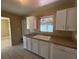 Cozy kitchen with white cabinetry, laminate countertops, and a double basin sink at 22332 Midway Blvd, Port Charlotte, FL 33952