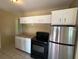 Traditional kitchen featuring a stainless steel refrigerator and white cabinets at 22332 Midway Blvd, Port Charlotte, FL 33952