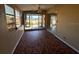 Enclosed sun room features tile flooring and glass windows overlooking yard at 22332 Midway Blvd, Port Charlotte, FL 33952
