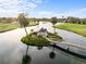 Scenic aerial view of a community's pond, foot bridge, and gazebo on its own island surrounded by mature landscaping at 2320 Terra Ceia Bay Blvd # 206, Palmetto, FL 34221