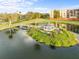 Beautiful aerial view of pond, foot bridge, and gazebo surrounded by mature landscaping and neighborhood buildings at 2320 Terra Ceia Bay Blvd # 206, Palmetto, FL 34221