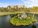 Aerial view of condo community pond, gazebo island, and residences with lush landscaping at 2320 Terra Ceia Bay Blvd # 206, Palmetto, FL 34221