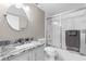 Bright bathroom with white vanity, a granite countertop, a round mirror and tiled shower with glass door at 2320 Terra Ceia Bay Blvd # 206, Palmetto, FL 34221