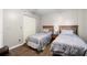 Neutral bedroom with hardwood floors, two twin beds, an end table and a closet at 2320 Terra Ceia Bay Blvd # 206, Palmetto, FL 34221