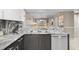 Close-up of the kitchen area showcasing granite countertops, stainless steel dishwasher, and seamless flow to the dining room at 2320 Terra Ceia Bay Blvd # 206, Palmetto, FL 34221