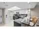 Well-lit kitchen featuring stainless steel appliances, granite countertops, and stylish barstool seating at 2320 Terra Ceia Bay Blvd # 206, Palmetto, FL 34221
