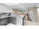 Modern kitchen with granite countertops, stainless steel dishwasher, and a view into the dining and living areas at 2320 Terra Ceia Bay Blvd # 206, Palmetto, FL 34221