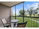 Relaxing screened-in lanai with cushioned chairs overlooking the community grounds at 2320 Terra Ceia Bay Blvd # 206, Palmetto, FL 34221