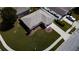 Aerial view showcasing a neatly landscaped home with a spacious yard, driveway, and a well-maintained roof at 2412 15Th W St, Palmetto, FL 34221