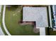 Aerial view of a home with a new roof, green lawn, and paved walkways highlighting the property's landscaping at 2412 15Th W St, Palmetto, FL 34221