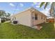 Exterior shot of the house displaying the manicured lawn, and backyard with an AC unit at 2412 15Th W St, Palmetto, FL 34221