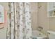 Bathroom with a white tub and charming seashell shower curtain, creating a cozy feel at 2412 15Th W St, Palmetto, FL 34221