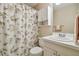 Bright bathroom featuring a seashell shower curtain and white vanity with storage at 2412 15Th W St, Palmetto, FL 34221