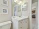 Bathroom with a white vanity, mirror, and seashell artwork at 2412 15Th W St, Palmetto, FL 34221