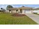 Charming single-story home featuring stone accents, an attached garage, and a beautifully landscaped front yard at 2412 15Th W St, Palmetto, FL 34221